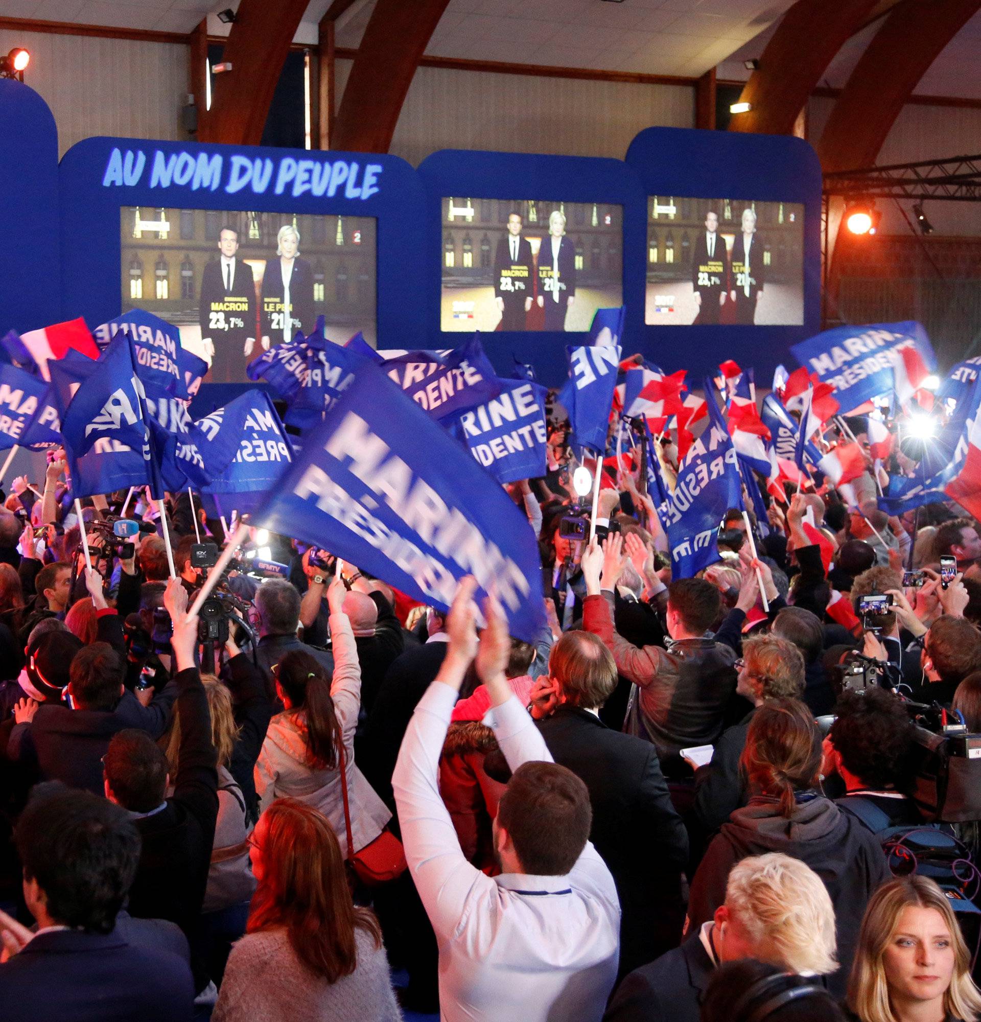 Supporters of Marine Le Pen, French National Front (FN) political party leader and candidate for French 2017 presidential election, react in Henin-Beaumont