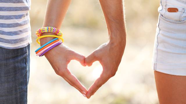 Happy couple holding hands, outdoors