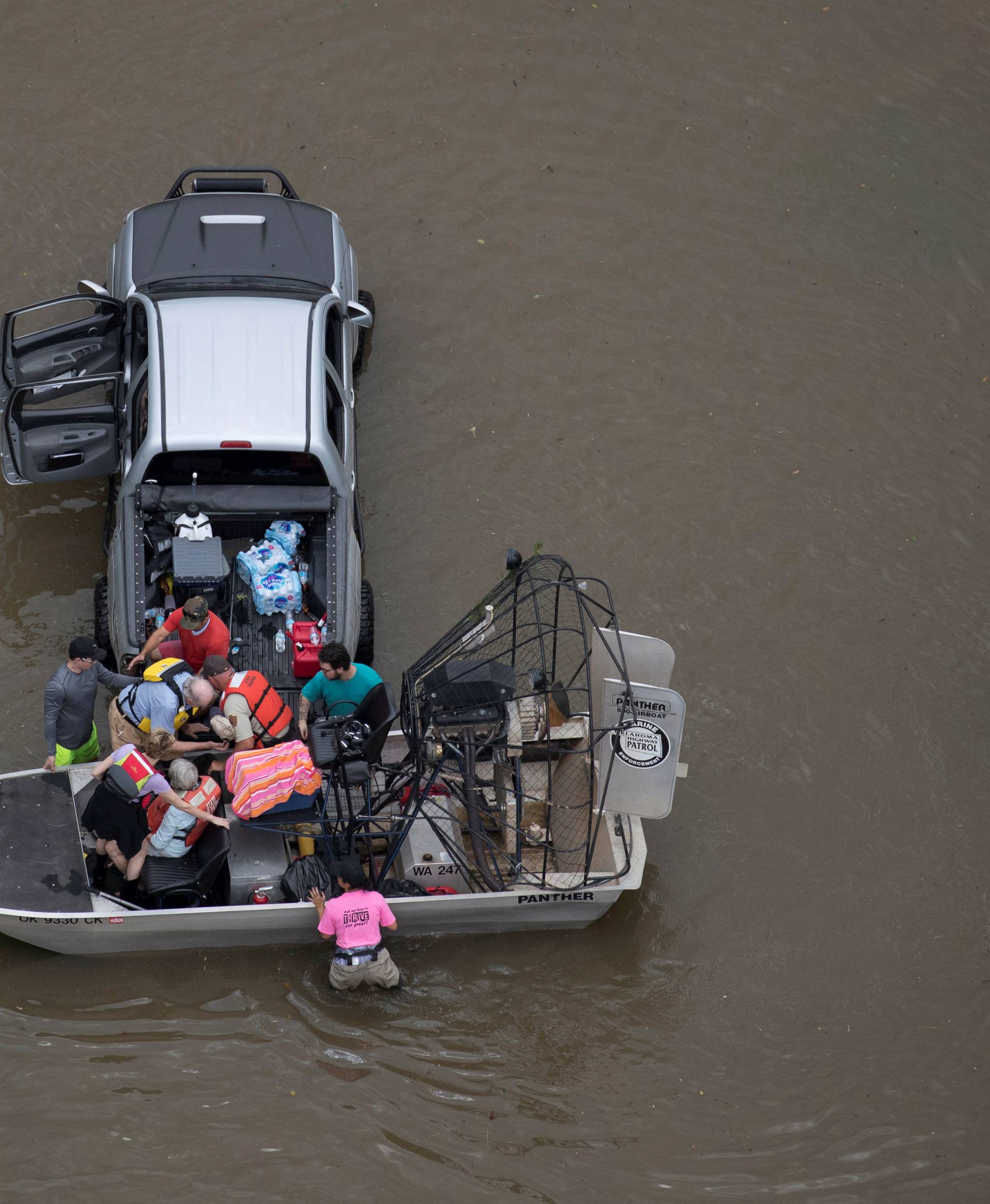 Residents are evacuated through flood waters caused by Tropical Storm Harvey in West Houston, Texas