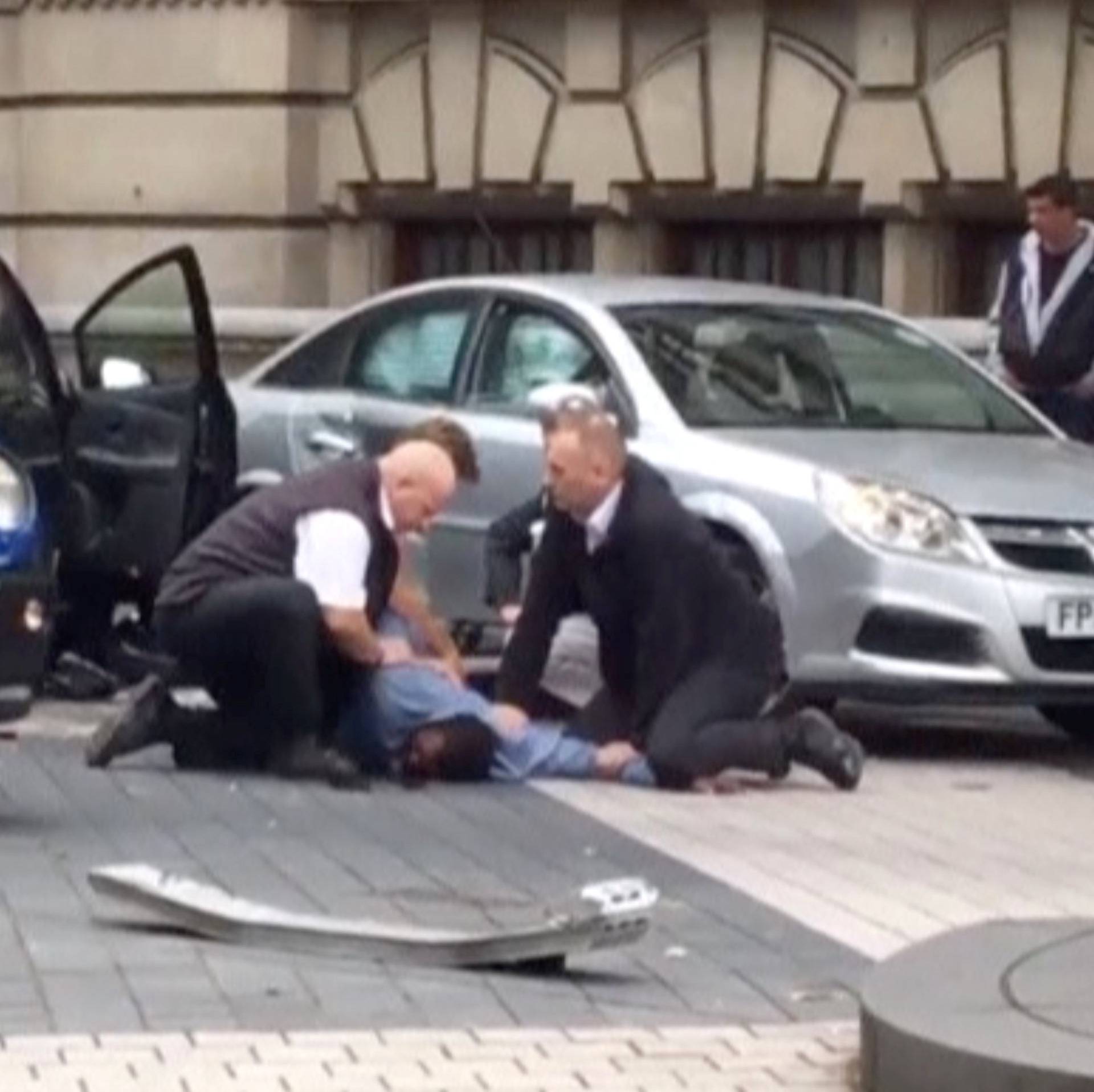 A man is being arrested by police near the Natural History Museum, in London, Britain, in this still image from a video