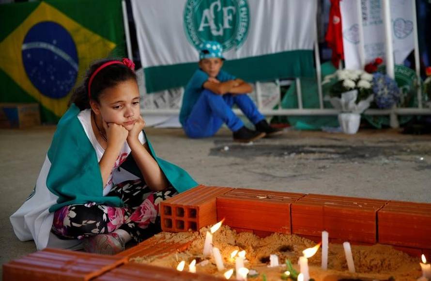 Young fans of Chapecoense soccer team pay tribute to Chapecoense's players at the Arena Conda stadium in Chapeco