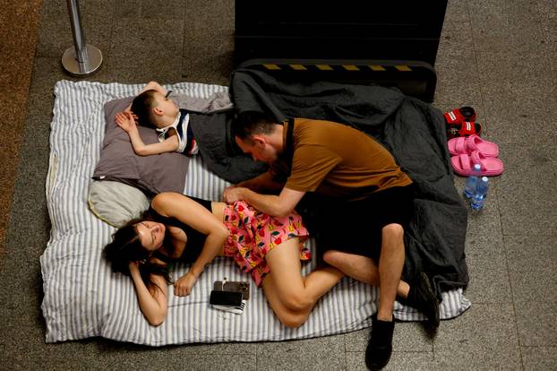 People take shelter inside a metro station during an air raid alert in Kyiv