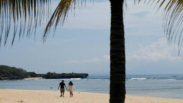 Tourists enjoy the beach in Nusa Dua, Bali