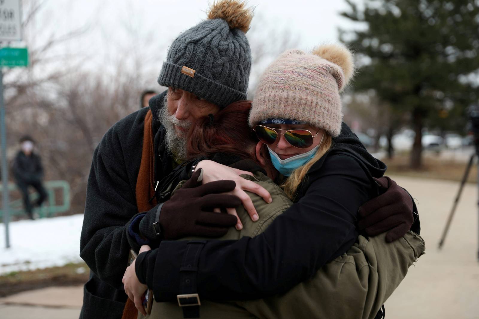 Sarah Moonshadow is comforted by David and Maggie Prowell after Moonshadow was inside King Soopers grocery store during a shooting in Boulder