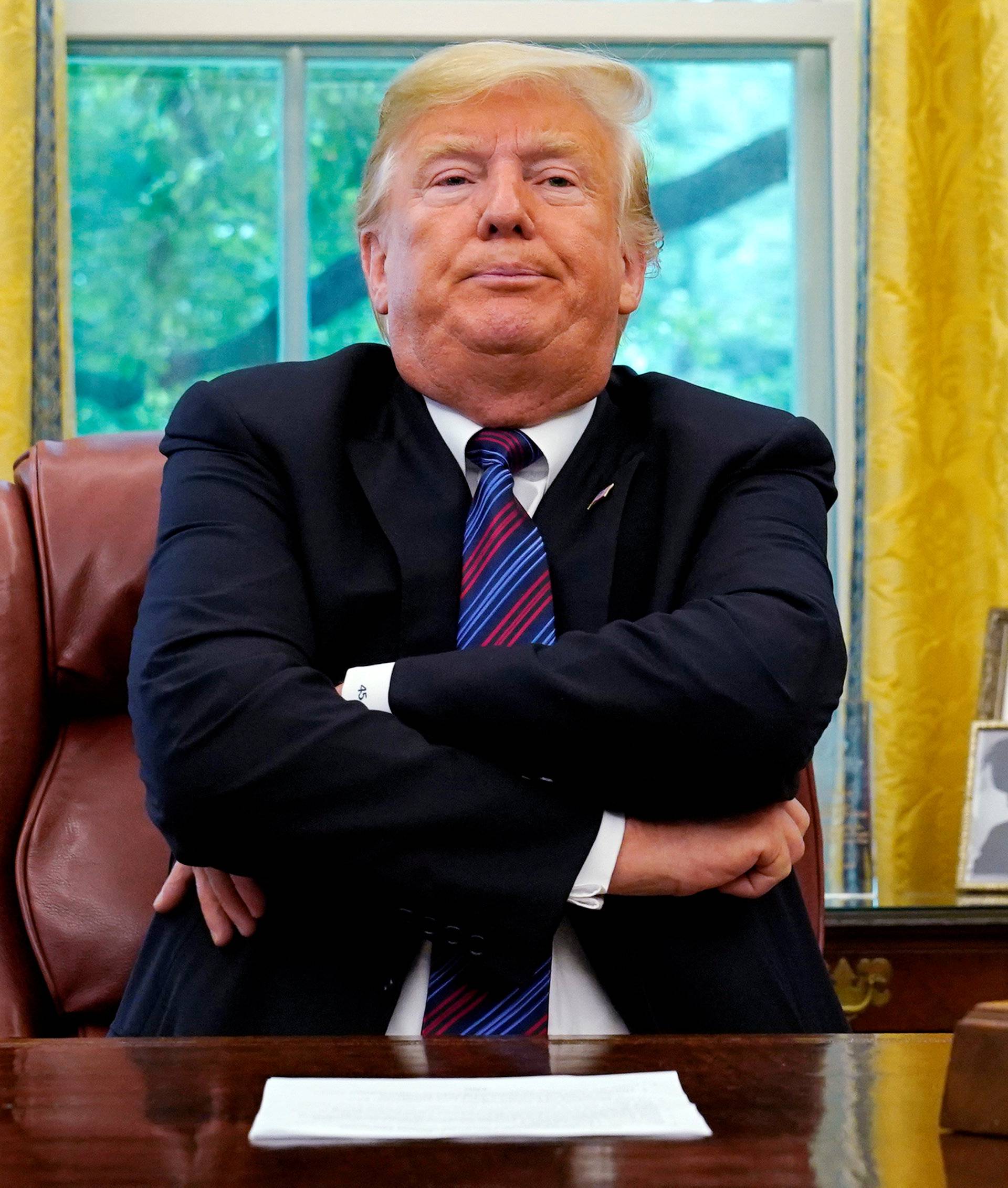 President Trump sits behind his desk as he makes announcement about a bilateral trade deal with Mexico at the White House in Washington