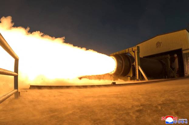 North Korea's Kim Jong Un observes a ground ejection test of a high-output solid-fuel engine using carbon fiber composite materials