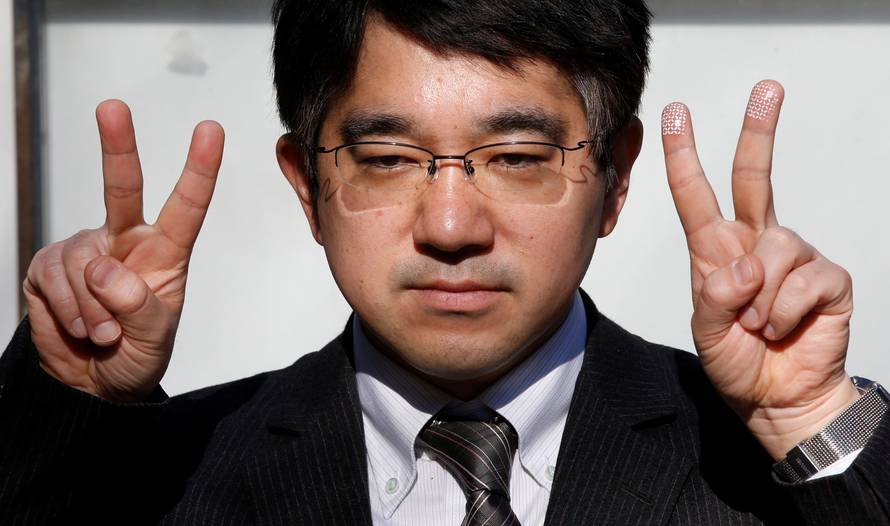 Echizen, a professor at Japan's National Institute of Informatics, gestures during a demonstration of his experiment for Reuters in Tokyo