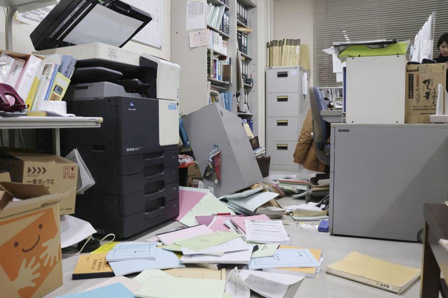 Bookshelves and documents that fell during an earthquake are seen at Kyodo News' Hakodate bureau in Hakodate