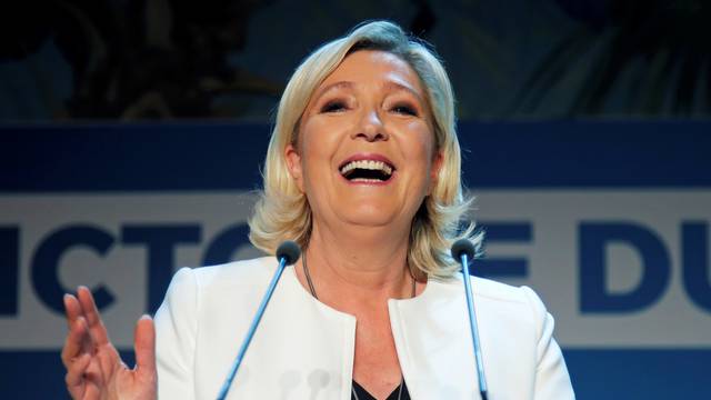 French far-right National Rally (Rassemblement National) party leader Marine Le Pen reacts after the first results in Paris