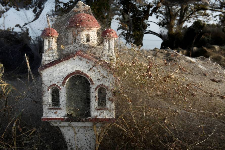 Spider webs cover a roadside shrine at the banks of Lake Vistonida