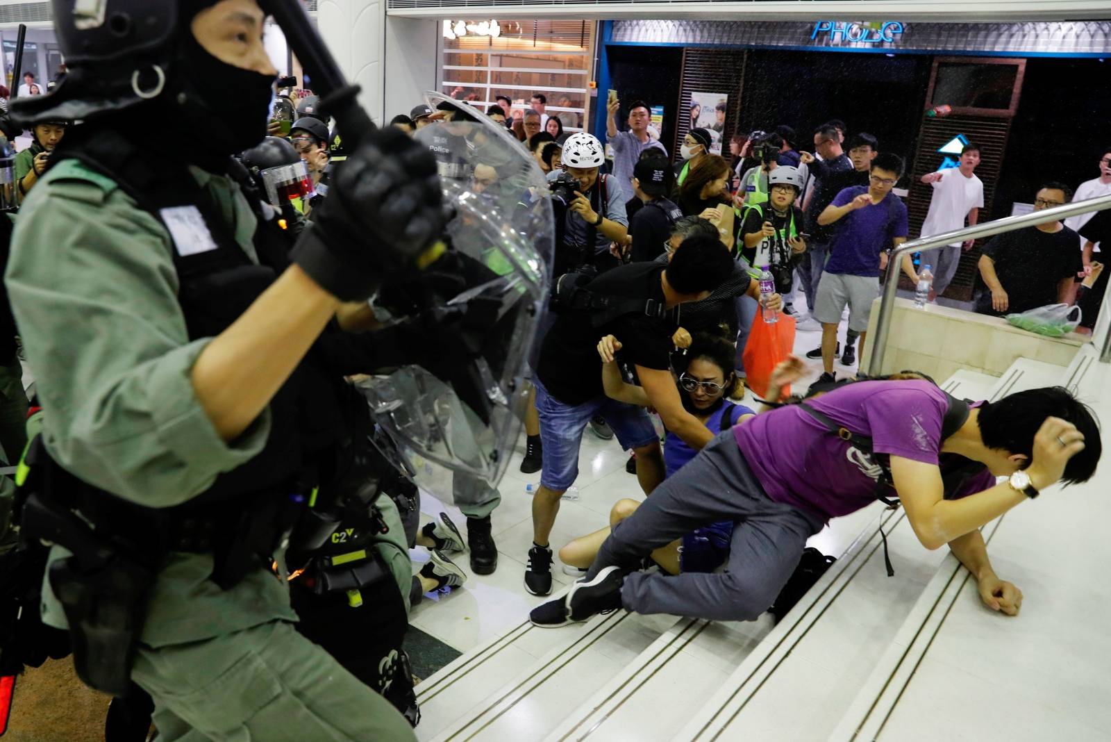 Riot police disperse anti-government protesters at a shopping mall in Tai Po, Hong Kong