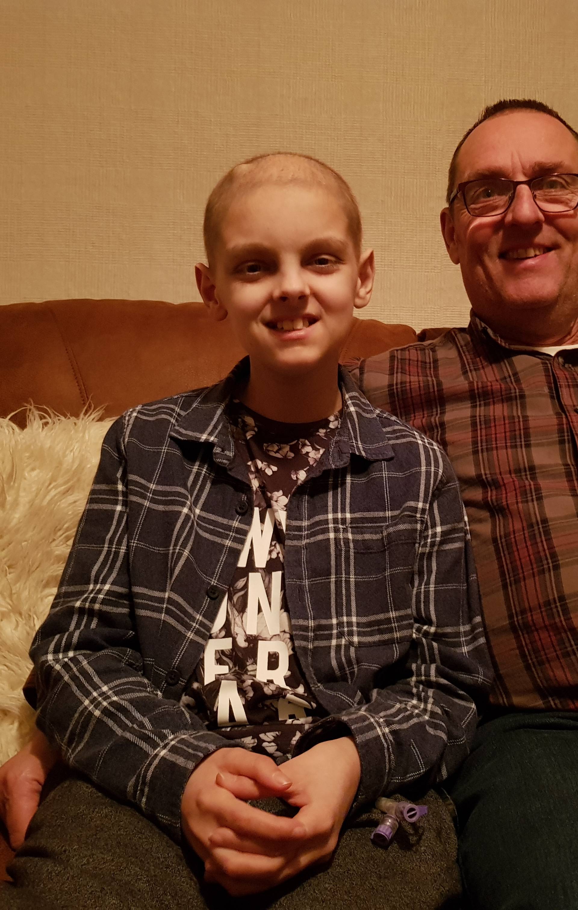 Elliot Smith and his father Bill at home in Yeovil, Somerset. Elliot has been using a robot to remotely access his school lessons whilst recovering from brain cancer Credit: Bill Smith