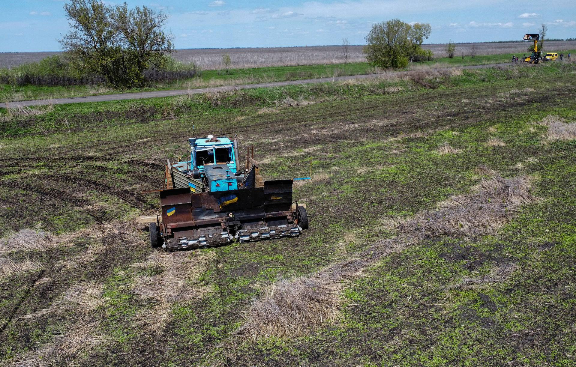 Remote controlled demining machine made of tractor and armoured plates from destroyed Russian military vehicles is seen in a field near the village of Hrakove