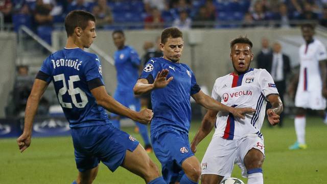 Dinamo Zagreb's Filip Benkovic and team mate Jonas in action with Olympique Lyon's Corentin Tolisso.