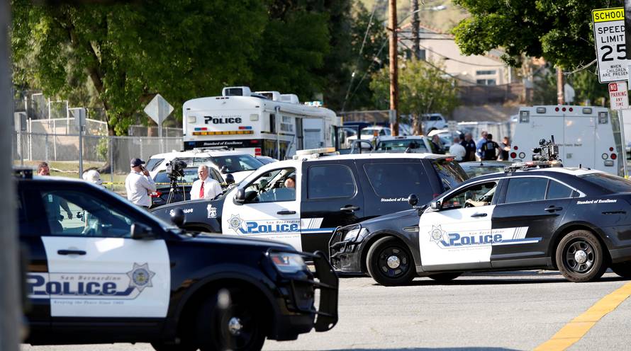 Police vehicles are pictured after a shooting at North Park Elementary School in San Bernardino