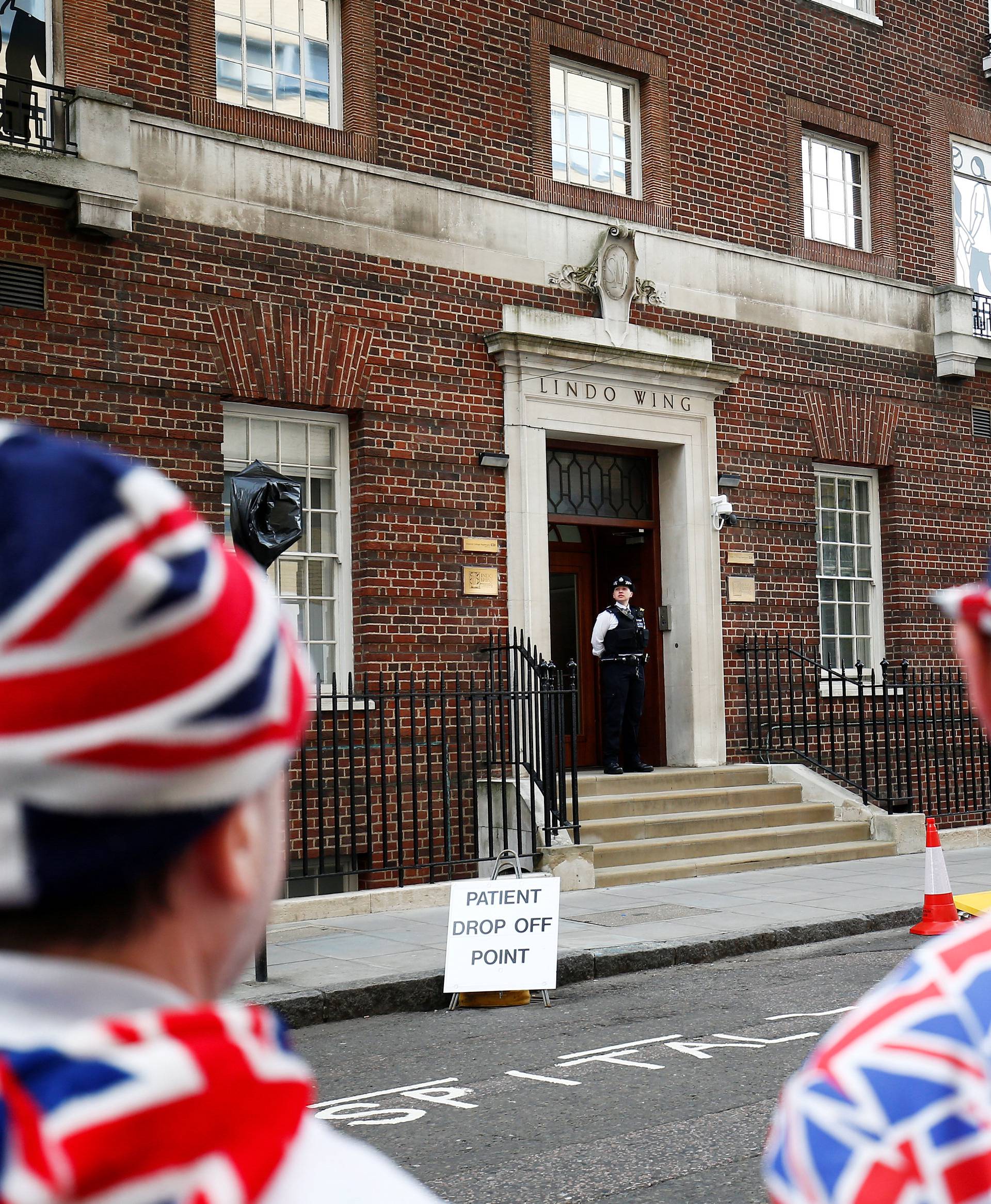 Supporters of the royal family stand outside the Lindo Wing of St Mary's Hospital after Britain's Catherine, the Duchess of Cambridge, was admitted after going into labour ahead of the birth of her third child, in London