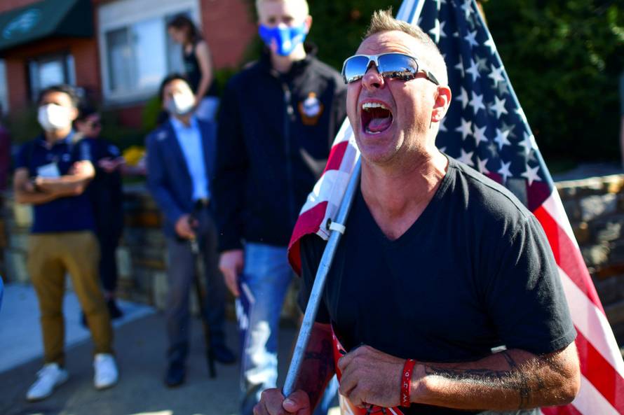 Michael Breitenbach, 47, screams at supporters of Democratic presidential nominee Joe Biden across the road after news media named Democratic presidential nominee Joe Biden the winner in the 2020 U.S. presidential election, in Philadelphia, Pennsylvania