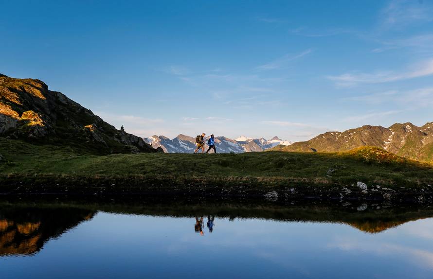 A couple hikes during sunrise on Kreuzjoch mountain in the Zillertal Alps in Schwendau