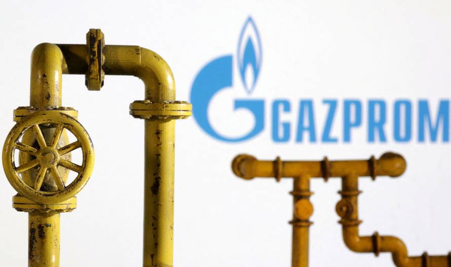 FILE PHOTO: Illustration shows natural gas pipeline and Gazprom logo