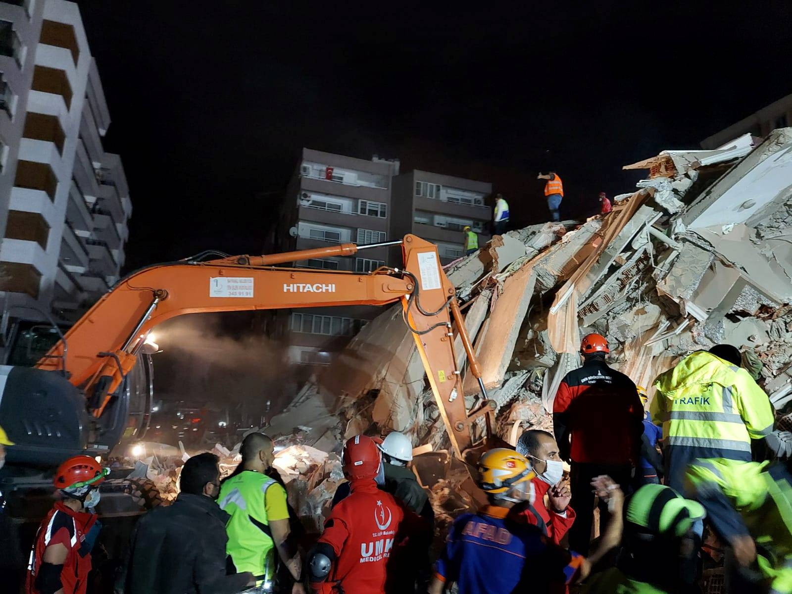 Rescque teams search for survivors at a collapsed building after a strong earthquake struck the Aegean Sea where some buildings collapsed in the coastal province of Izmir