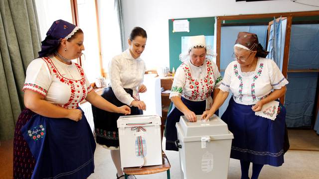 Hungarian women wearing traditional costumes attend a referendum on EU migrant quotas in Veresegyhaz