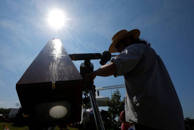 Photographer C.D. Olsen adjusts his replica of the Kew Photo Heliograph outside the football stadium at Southern Illinois University in Carbondale