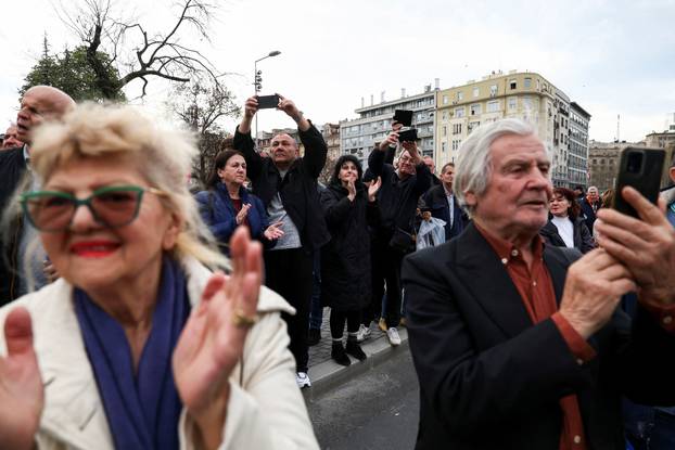 People attend a rally in support of policies of the President Aleksandar Vucic