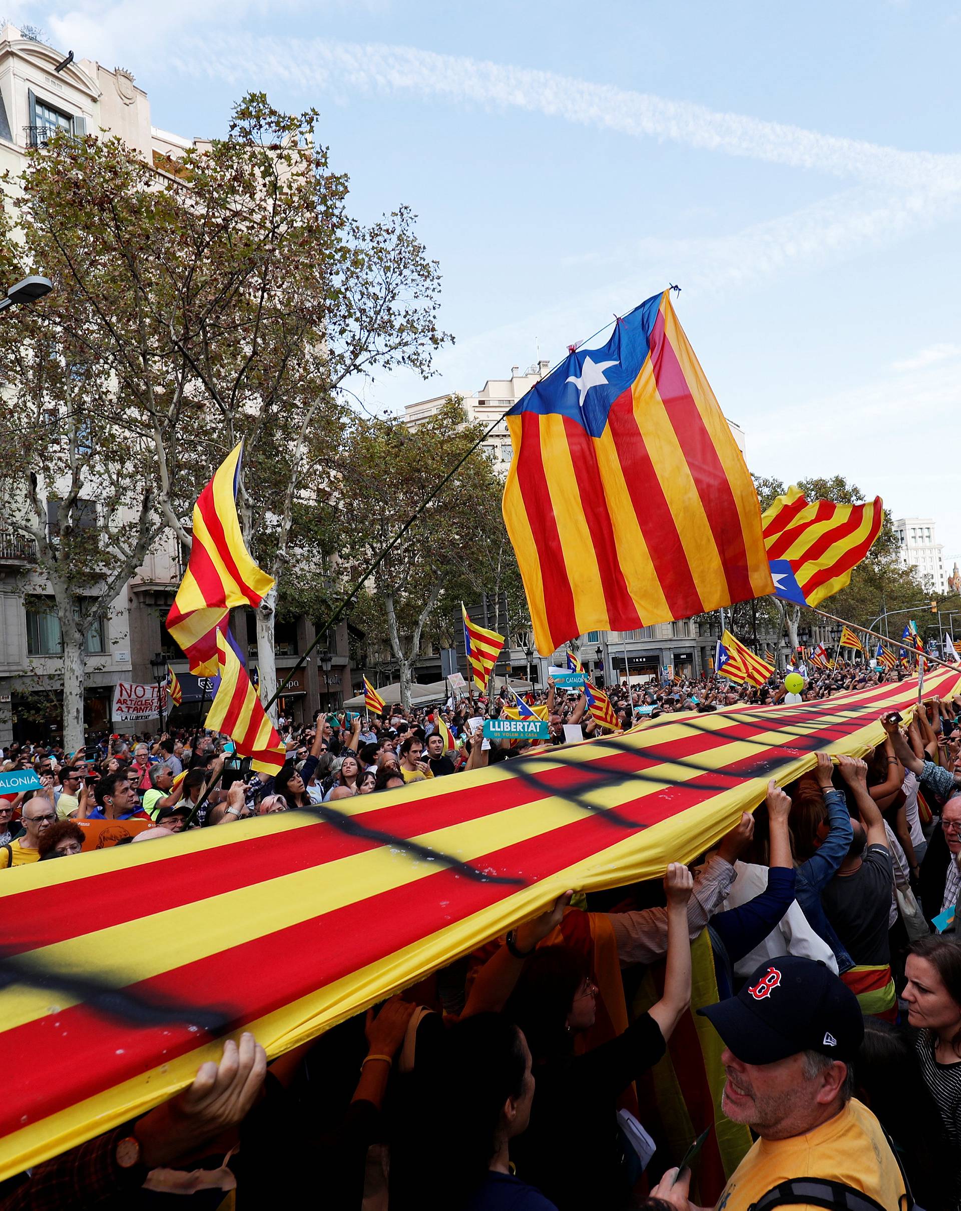 People wave separatist Catalan flags during a demonstration organised by Catalan pro-independence movements ANC (Catalan National Assembly) and Omnium Cutural, following the imprisonment of their two leaders, in