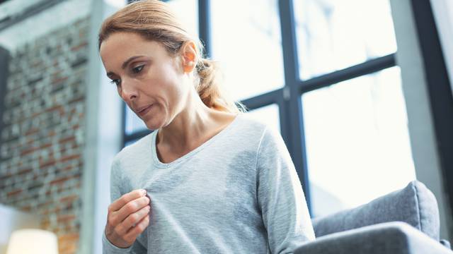 Exhausted mature woman entering menopause