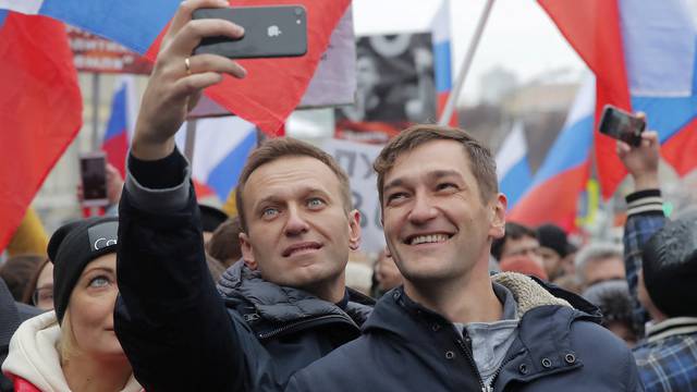 FILE PHOTO: Russian opposition leader Alexei Navalny and his brother Oleg attend a rally in memory of politician Boris Nemtsov in Moscow