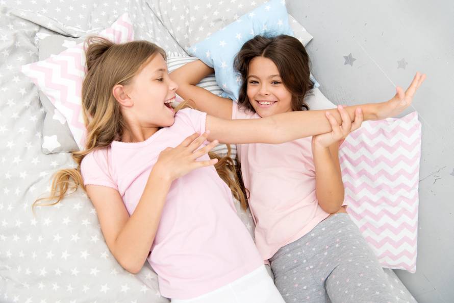 Slumber party concept. Girls just want to have fun. Invite friend for sleepover. Best friends forever. Consider theme slumber party. Slumber party timeless childhood tradition. Girls relaxing on bed