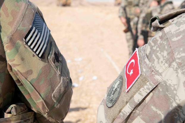 U.S. and Turkish military forces conduct a joint ground patrol in northeast Syria