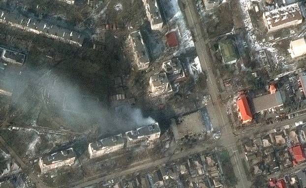 A satellite image shows burning apartment buildings at Zelinskovo street, in the western section of Mariupol