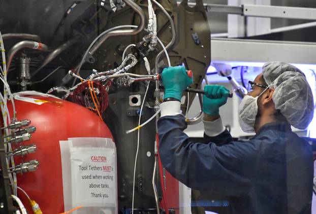 SpaceX technicians work on the next Crew Dragon Demo-2 craft as NASA Administrator Jim Bridenstine tours SpaceX headquarters with NASA astronauts Bob Behnken and Doug Hurley in Hawthorne