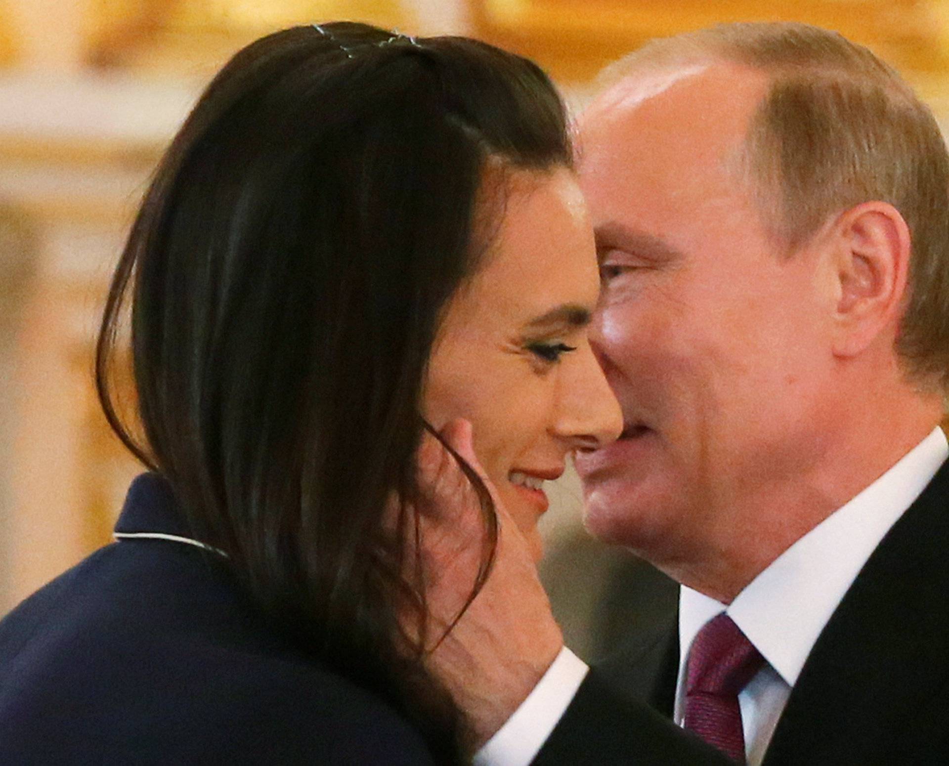 Russian President Putin greets track-and-field athlete Isinbayeva during personal send-off for members of Russian Olympic team at Kremlin in Moscow