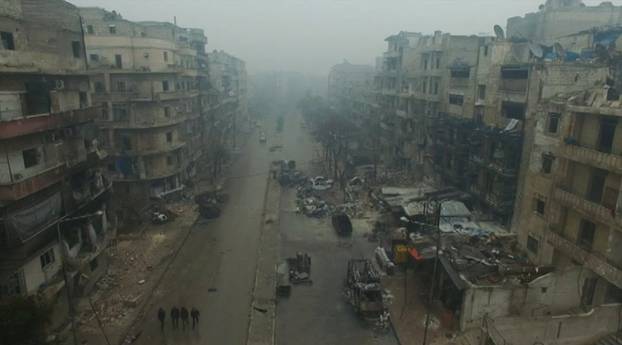 A still image from video taken December 13, 2016 of a general view of bomb damaged eastern Aleppo, Syria in the rain