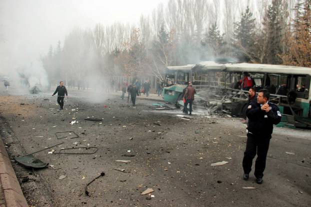 People react after a bus was hit by an explosion in Kayseri