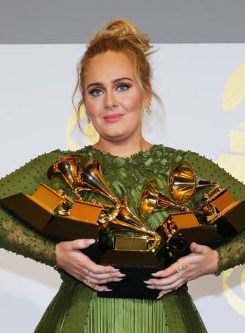 Adele holds her five Grammys during the 59th Annual Grammy Awards in Los Angeles