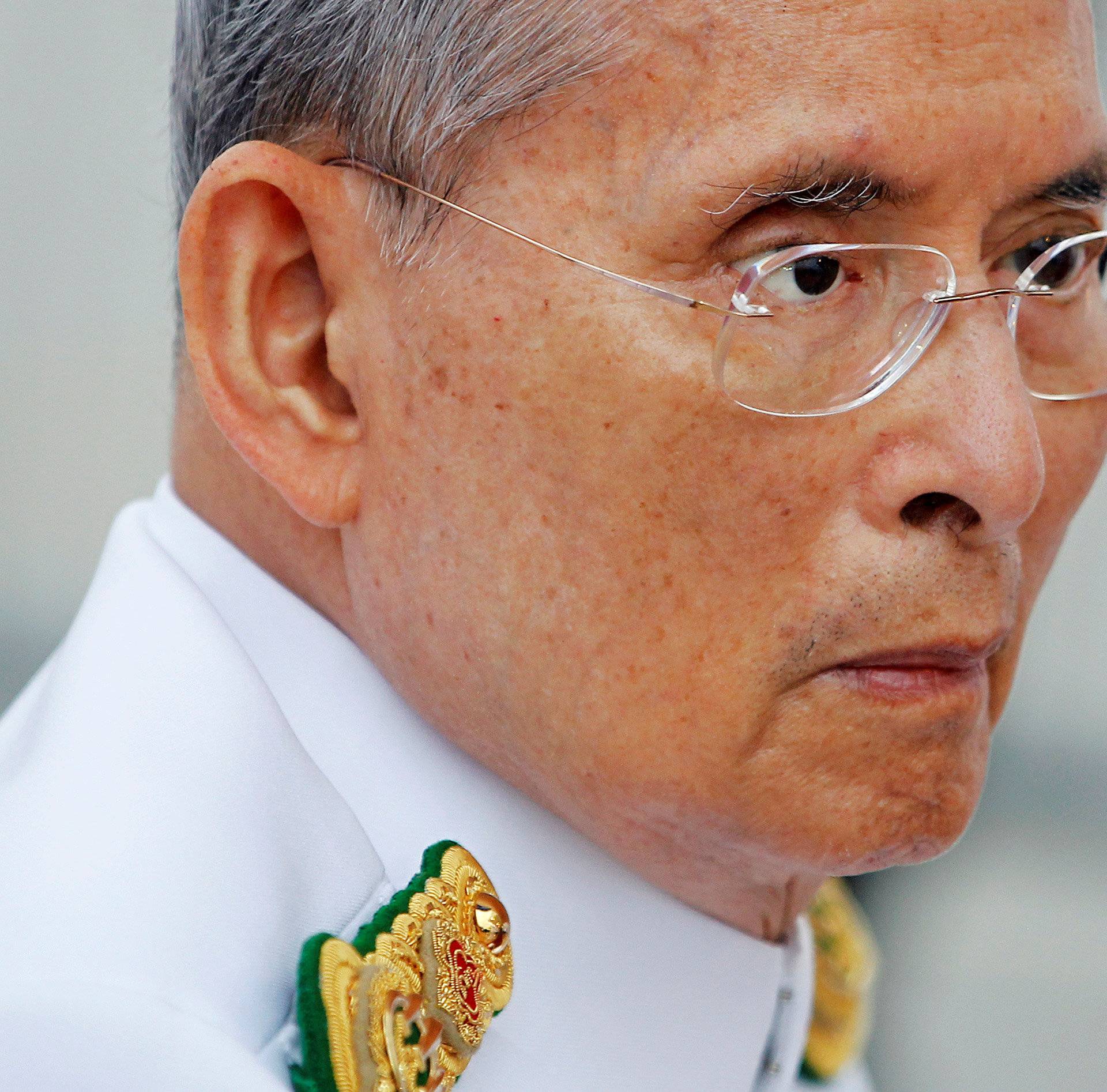 Thailand's King Bhumibol Adulyadej arrives to preside over the unveiling ceremony for the King Rama VIII monument in Bangkok