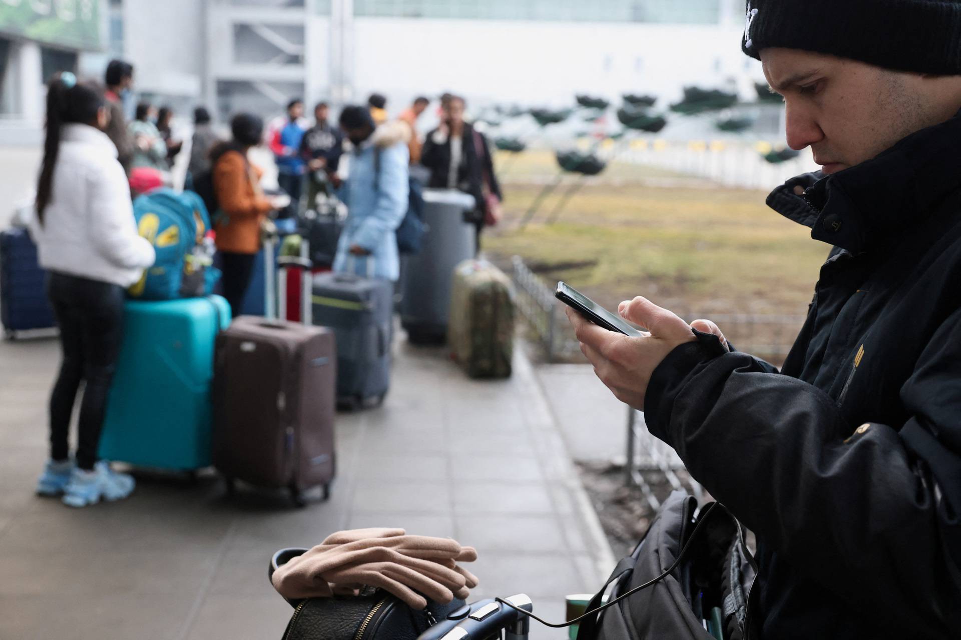 People wait at Kyiv Airport after Russian President Vladimir Putin authorized a military operation in eastern Ukraine