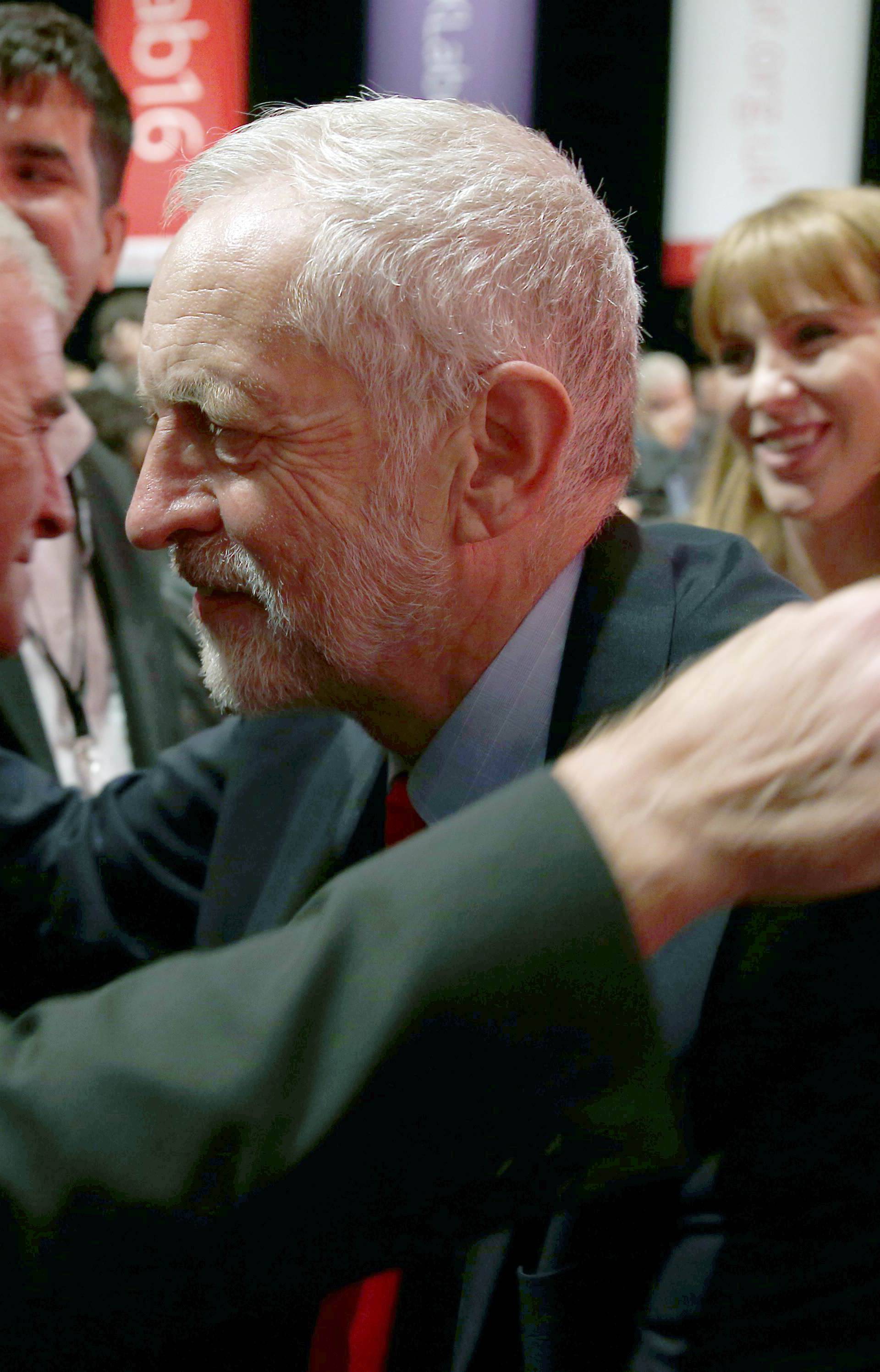 The leader of Britain's opposition Labour Party, Jeremy Corbyn, is embraced by Shadow Chancellor John McDonnell after the announcement of Corbyn's victory in the party's leadership election, in Liverpool