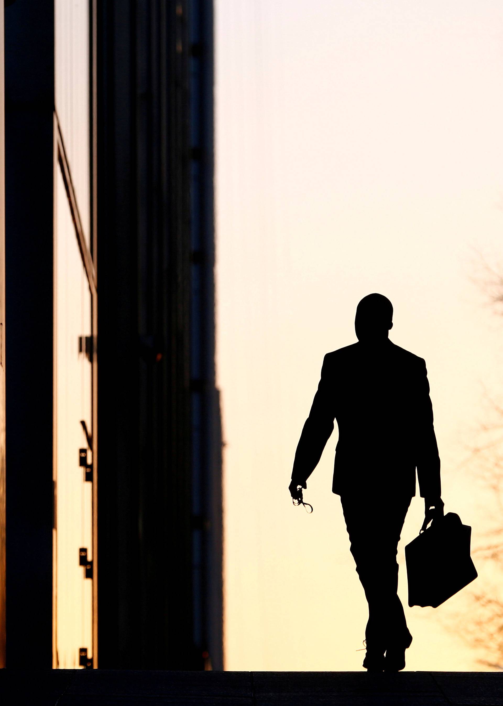 A worker arrives at his office in the Canary Wharf business district in London