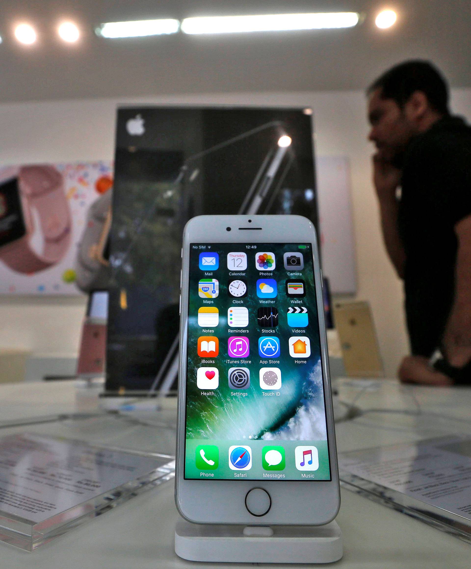 FILE PHOTO: An iPhone is seen on display at a kiosk at an Apple reseller store in Mumbai