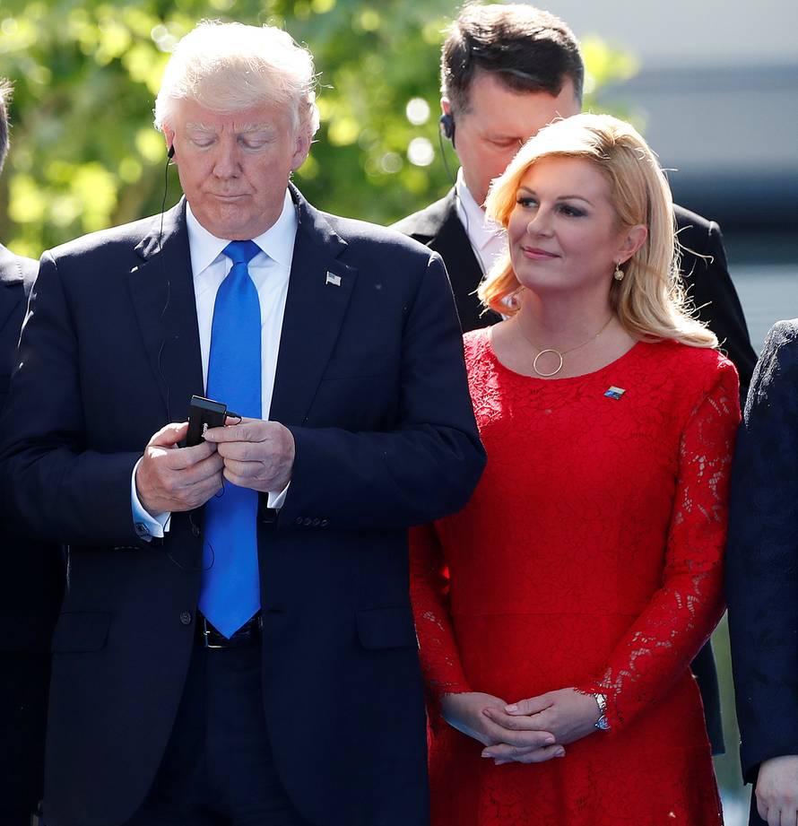 U.S. President Donald Trump reacts at the start of the NATO summit at their new headquarters in Brussels