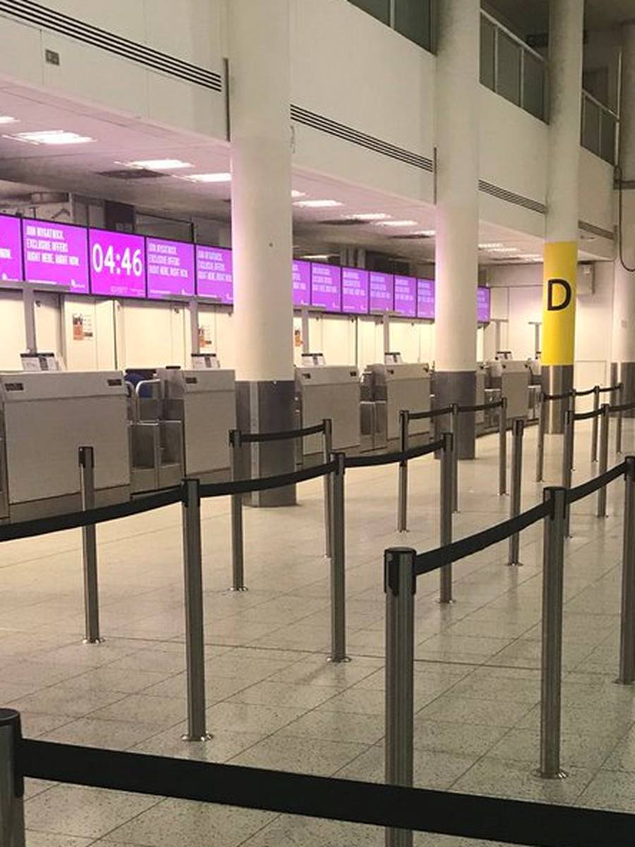 An empty check-in desk for Monarch Airlines is pictured at Gatwick Airport, London