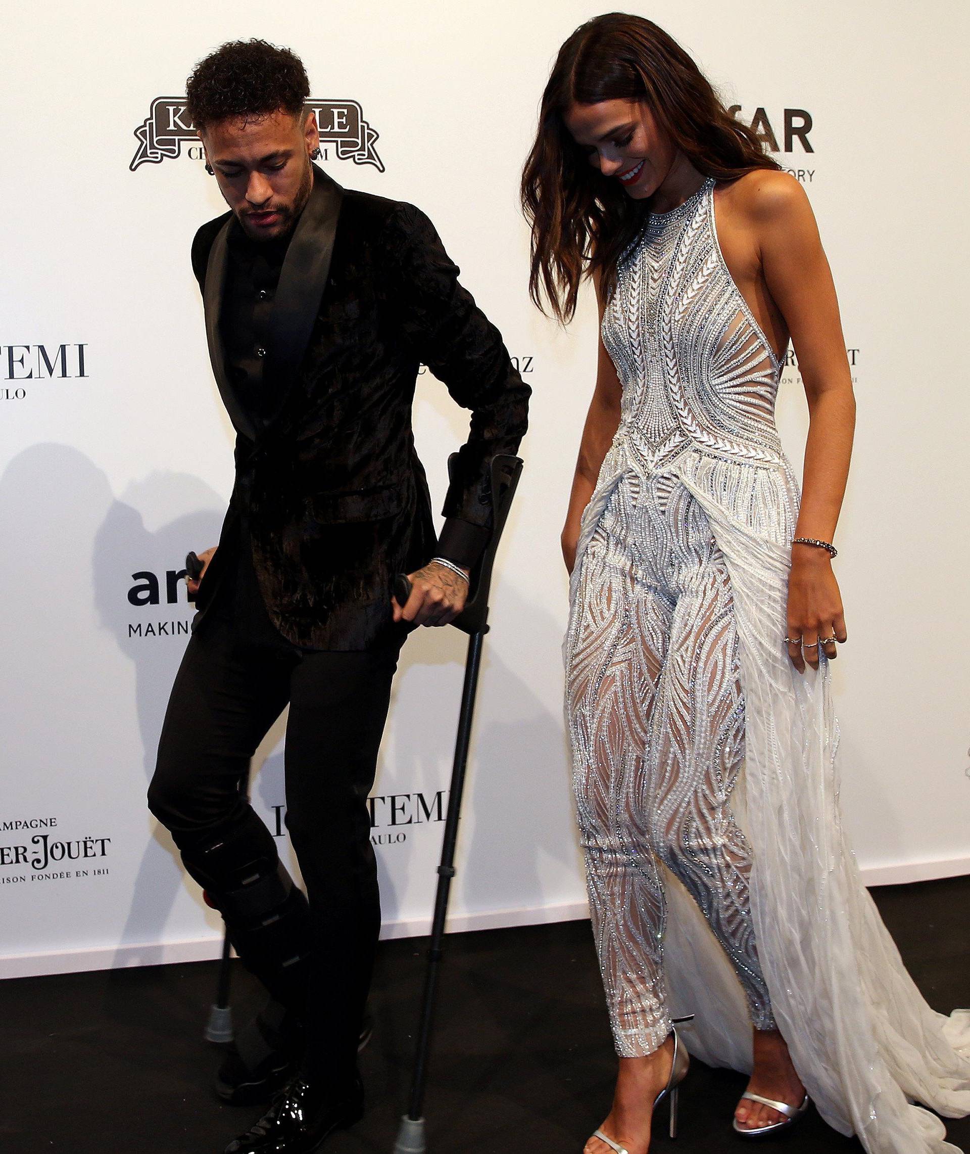 Soccer player Neymar and his girlfriend Bruna Marquezine arrive at the eighth annual amfAR Gala Sao Paulo