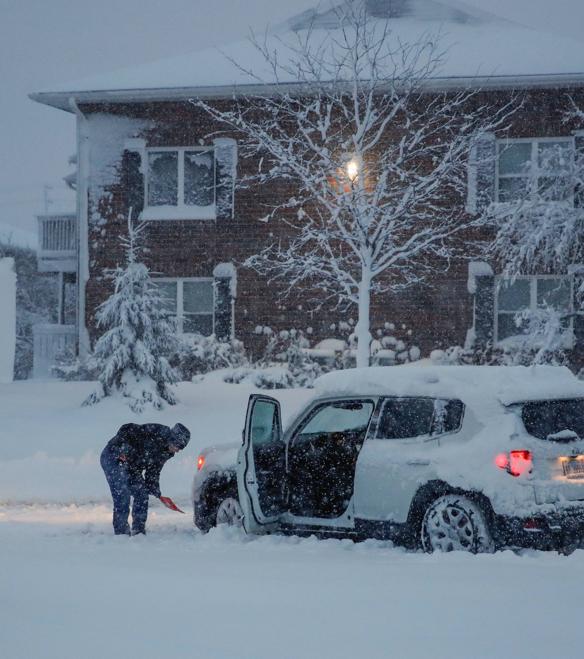 Woman shovels snow in Arlington Heights