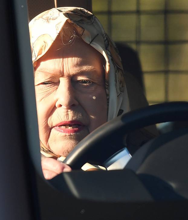 The Queen drives through Sandringham