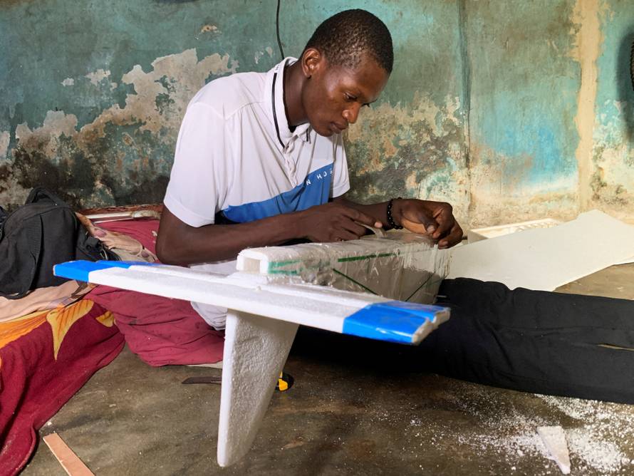 Bolaji Fatai builds a model aeroplane from discarded waste in Lagos