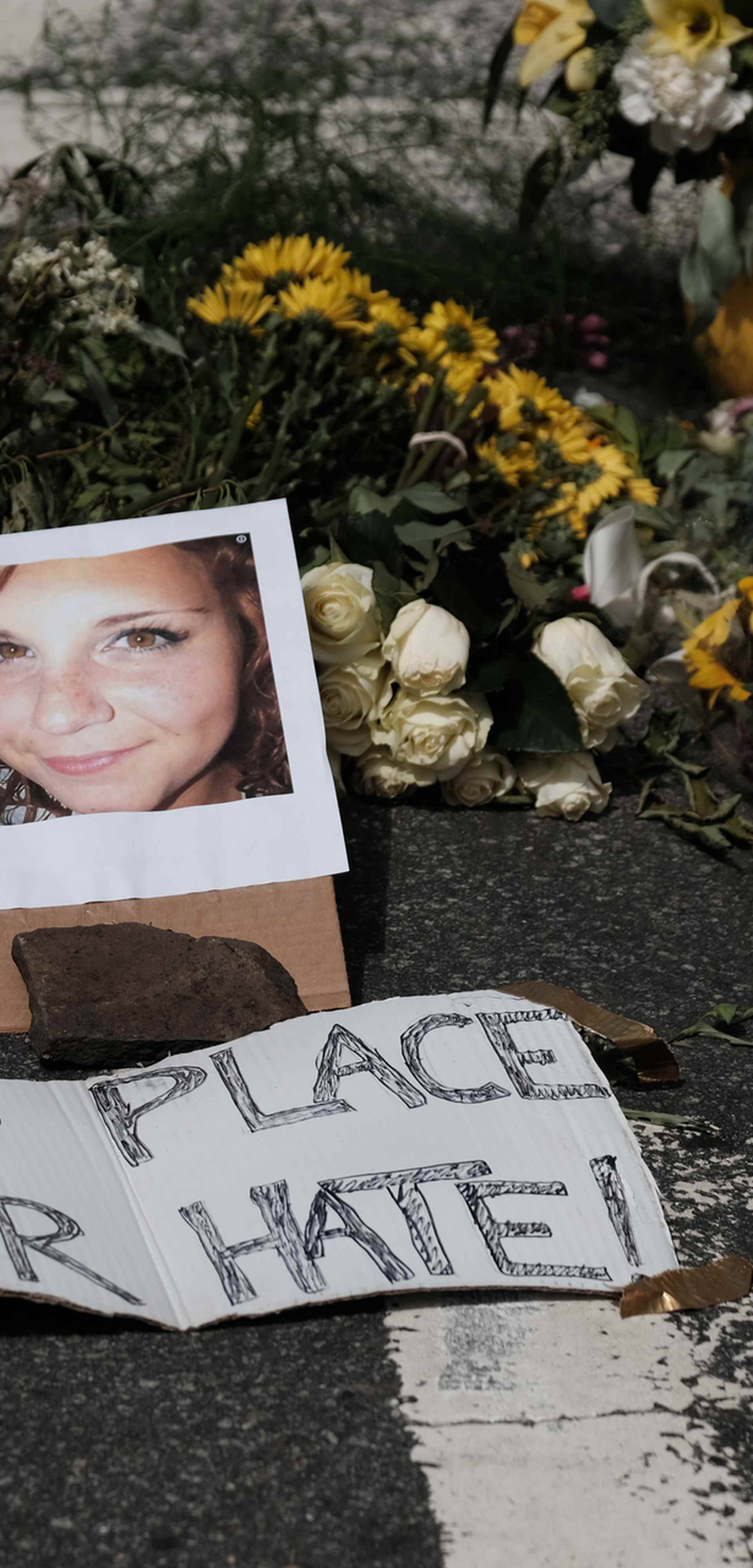 Flowers and a photo of car ramming victim Heather Heyer lie at a makeshift memoriall in Charlottesville